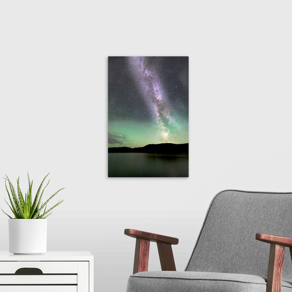 A modern room featuring Aurora borealis and Milky Way above Fish Lake, Whitehorse, Yukon, Canada.
