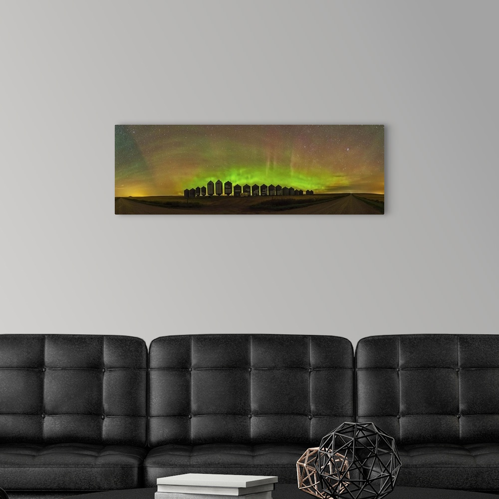 A modern room featuring A 180 degree panorama of a modest aurora display behind grain bins on a country road in Alberta, ...
