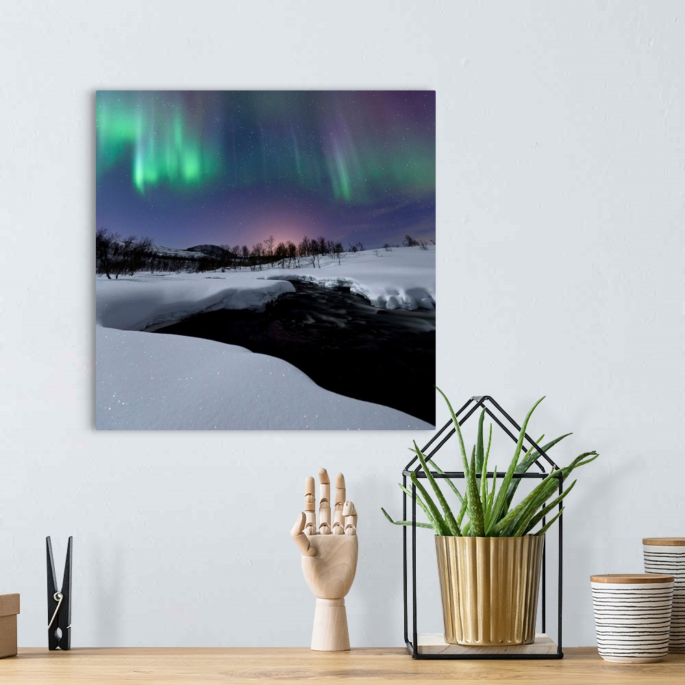 A bohemian room featuring Aurora Borealis over Blafjellelva RIver in Troms County, Norway. Auroras are the result of the em...