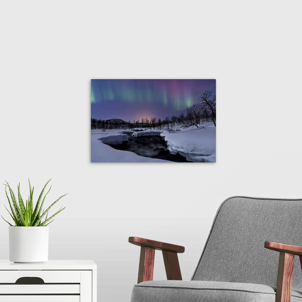 A modern room featuring Aurora Borealis over Blafjellelva RIver in Troms County, Norway. Auroras are the result of the em...