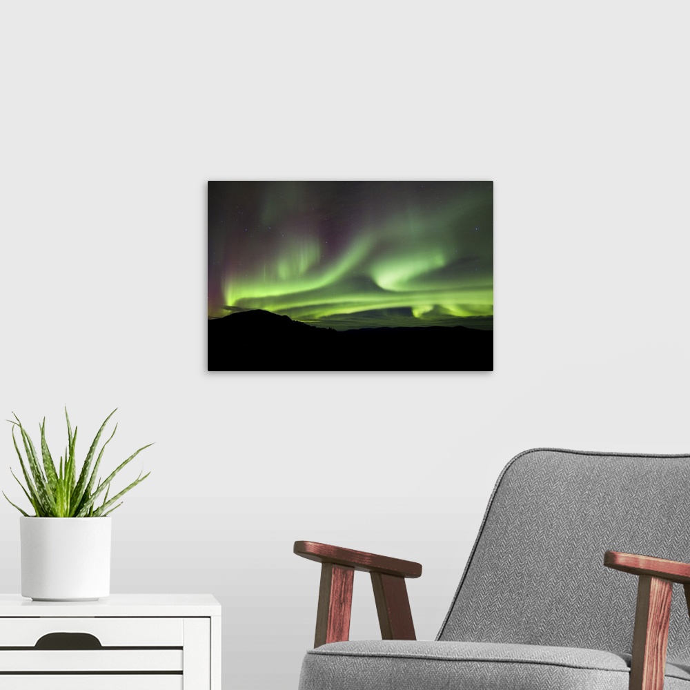 A modern room featuring Aurora borealis over Gray Peak, Whitehorse, Yukon Canada.