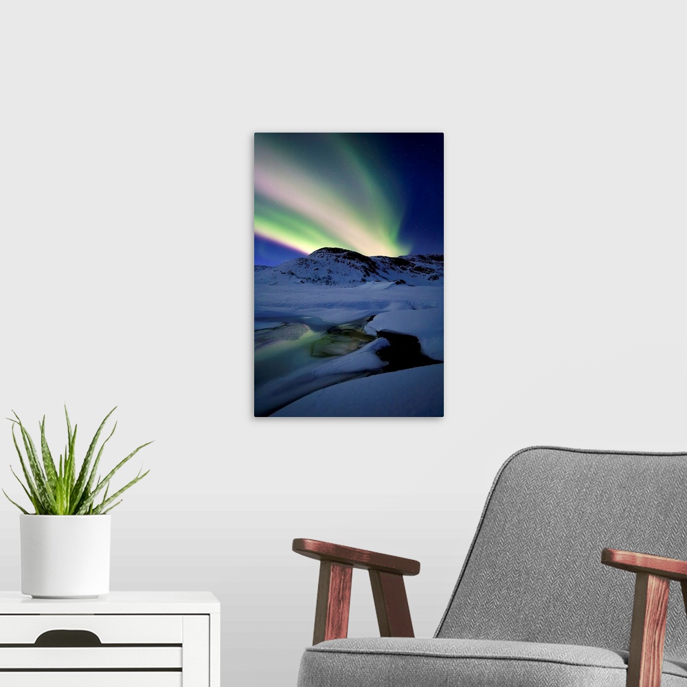 A modern room featuring Aurora Borealis over Mikkelfjellet Mountain in Troms County, Norway. Auroras are the result of th...
