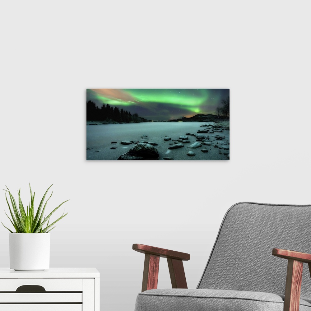 A modern room featuring Horizontal, large photograph of the rocky shoreline of Sandvannet Lake in Troms County, Norway, w...