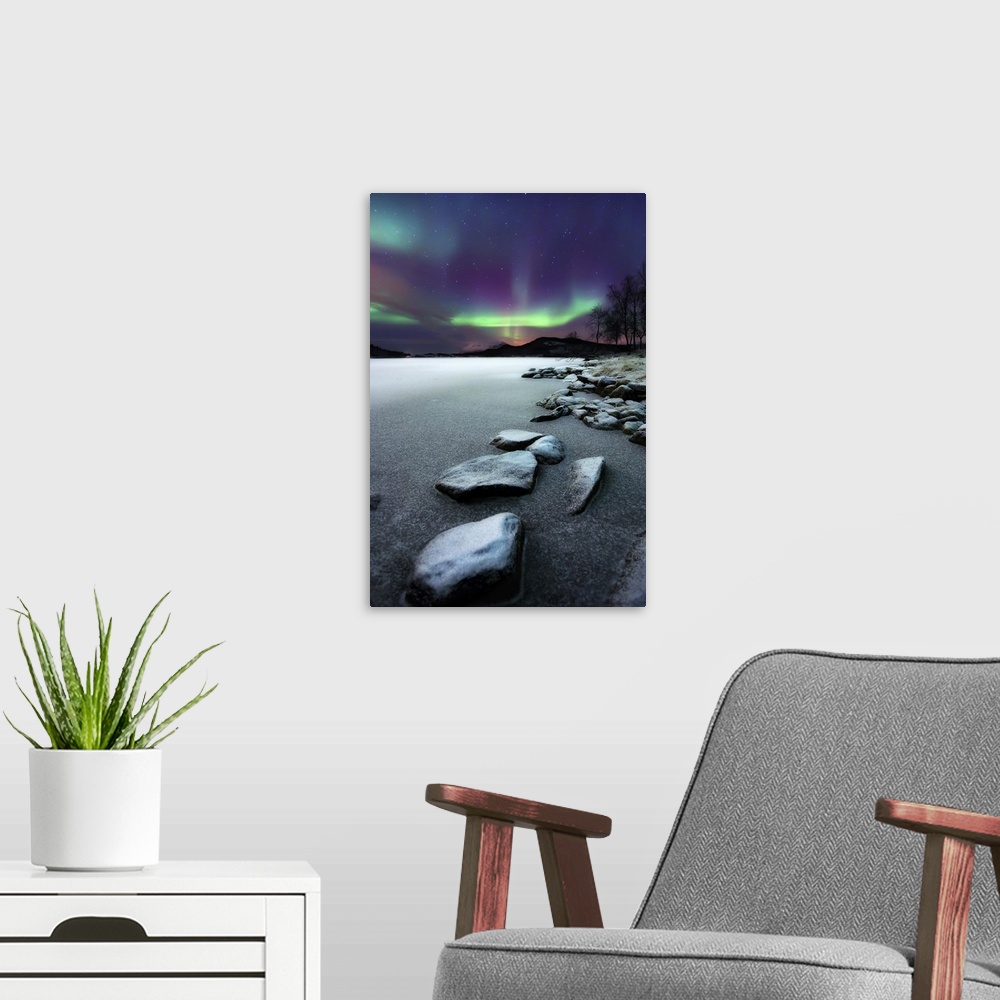 A modern room featuring Aurora Borealis over Sandvannet Lake in Troms County, Norway. Auroras are the result of the emiss...