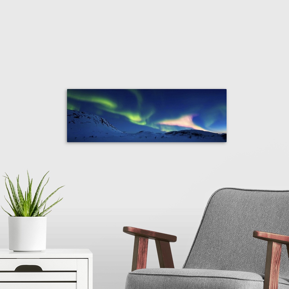 A modern room featuring Aurora Borealis over Skittendalen Valley, Troms County, Norway. Auroras are the result of the emi...