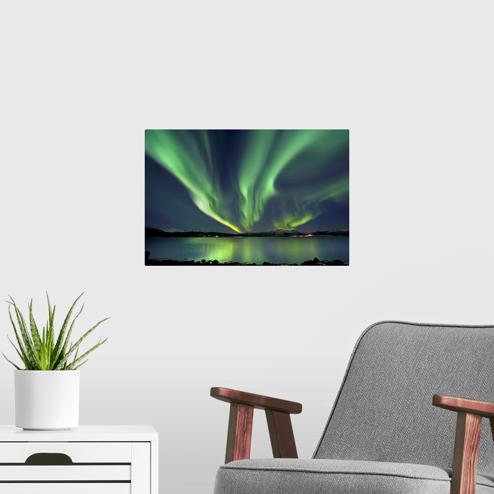 A modern room featuring Aurora Borealis over Tjeldsundet in Troms County, Norway. Auroras are the result of the emissions...