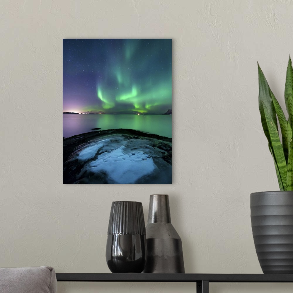 A modern room featuring Aurora Borealis over Vagsfjorden outside of Harstad in Northern Norway. Auroras are the result of...