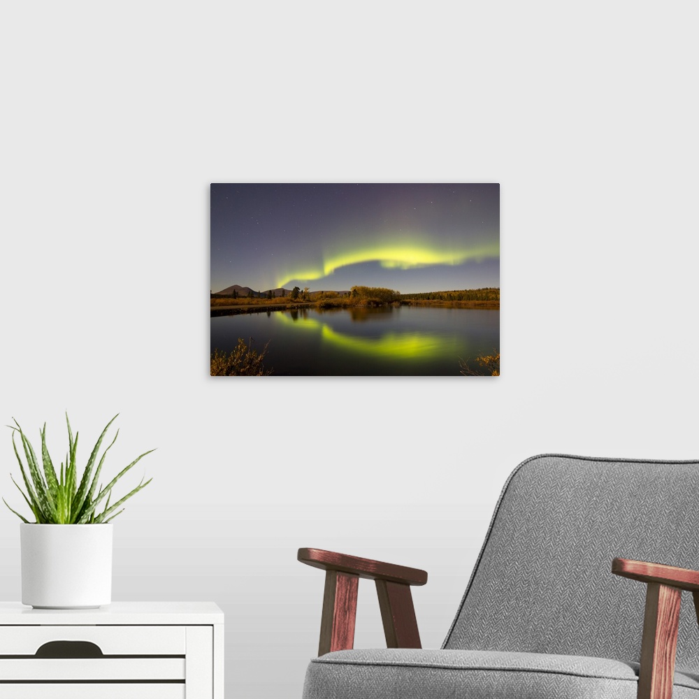 A modern room featuring Aurora borealis with moonlight at Fish Lake, Whitehorse, Yukon, Canada.