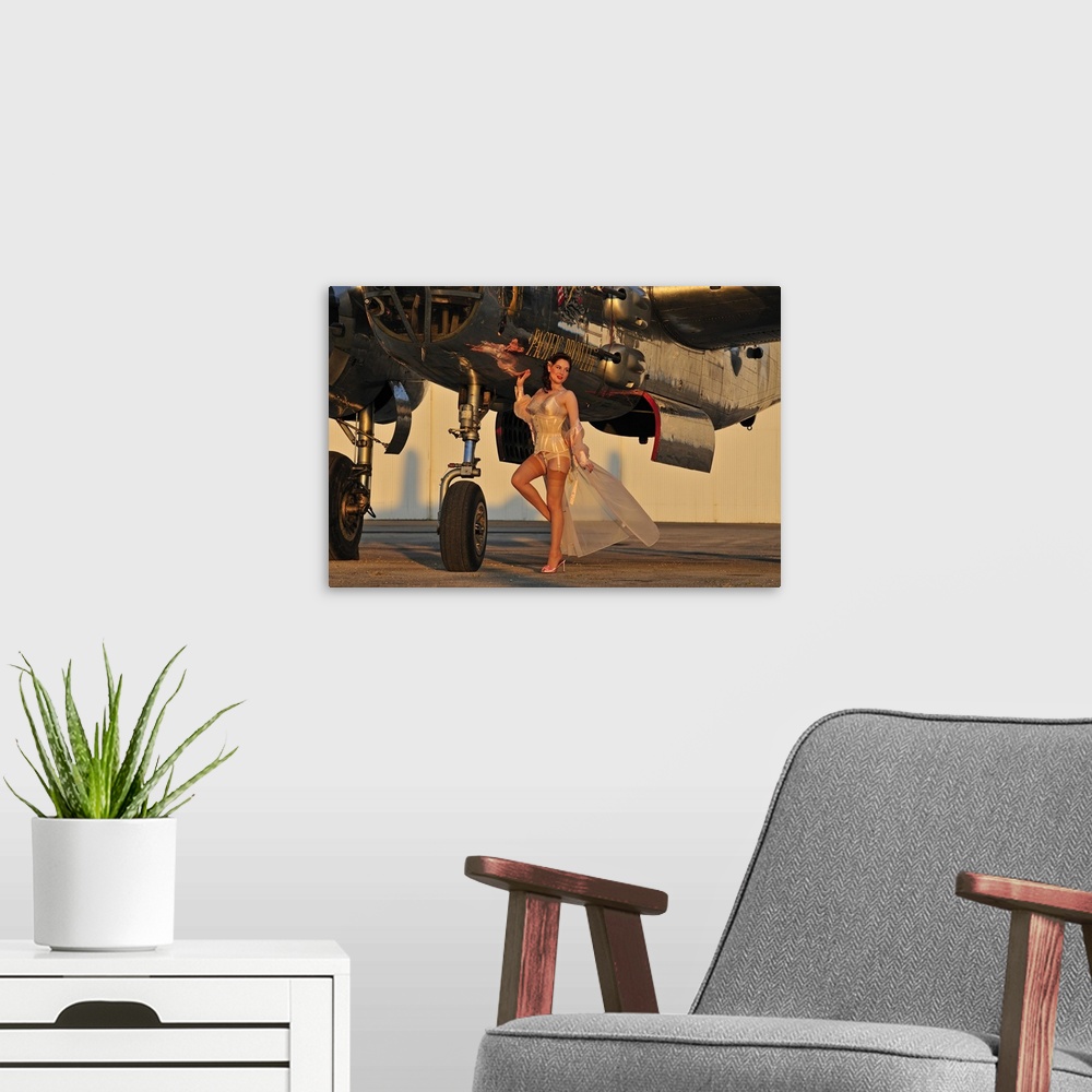 A modern room featuring Beautiful 1940's pin-up girl standing with a B-25 bomber.
