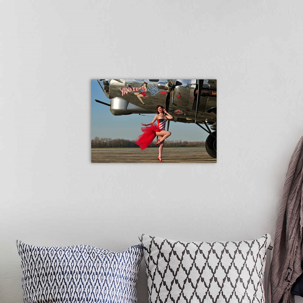 A bohemian room featuring Beautiful 1940's style pin-up girl standing in front of a B-17 bomber.