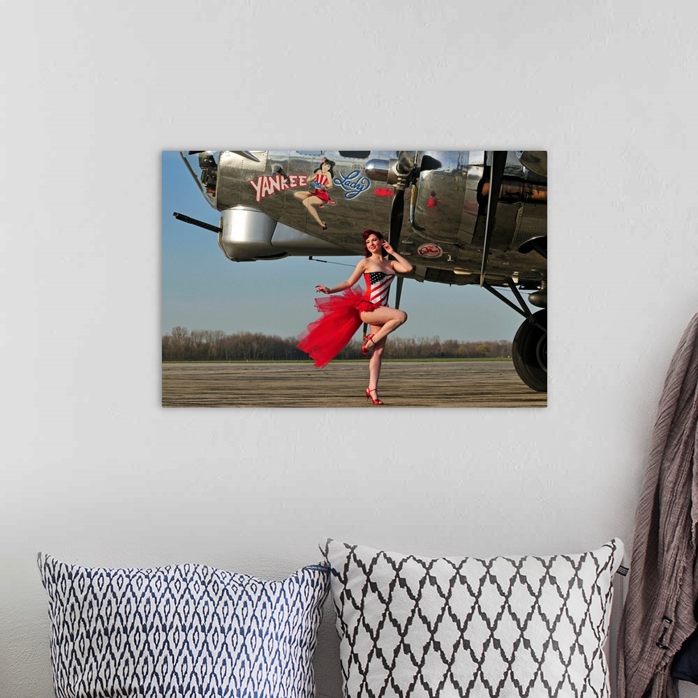 A bohemian room featuring Beautiful 1940's style pin-up girl standing in front of a B-17 bomber.