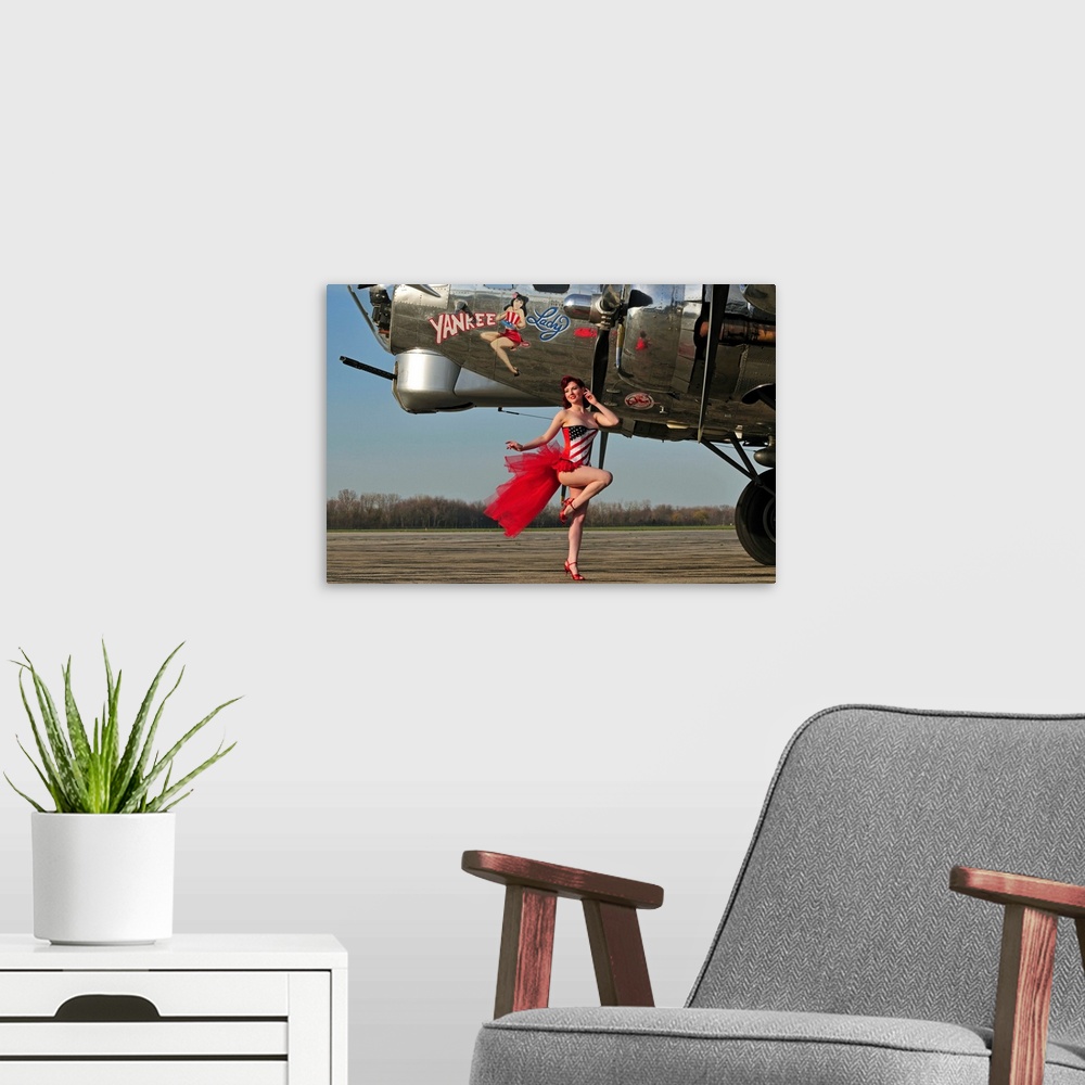 A modern room featuring Beautiful 1940's style pin-up girl standing in front of a B-17 bomber.