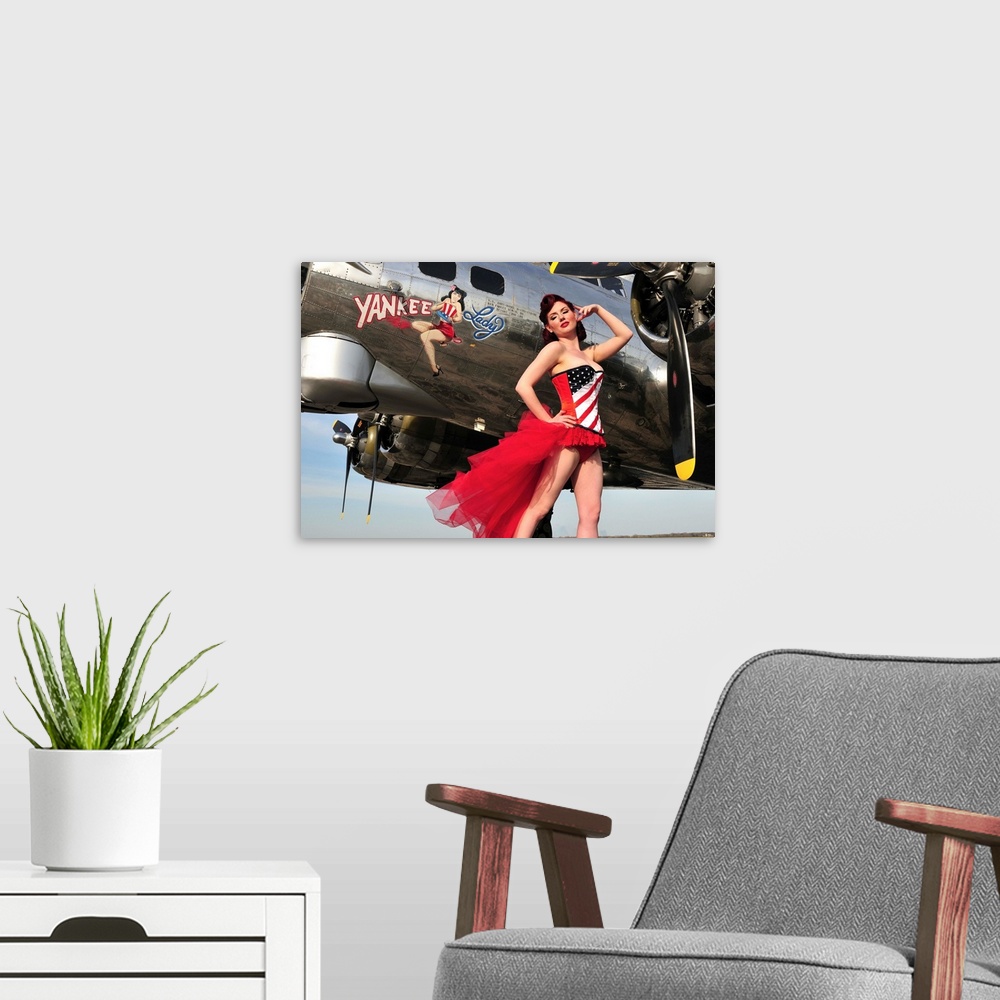 A modern room featuring Beautiful 1940's style pin-up girl standing under a B-17 bomber.