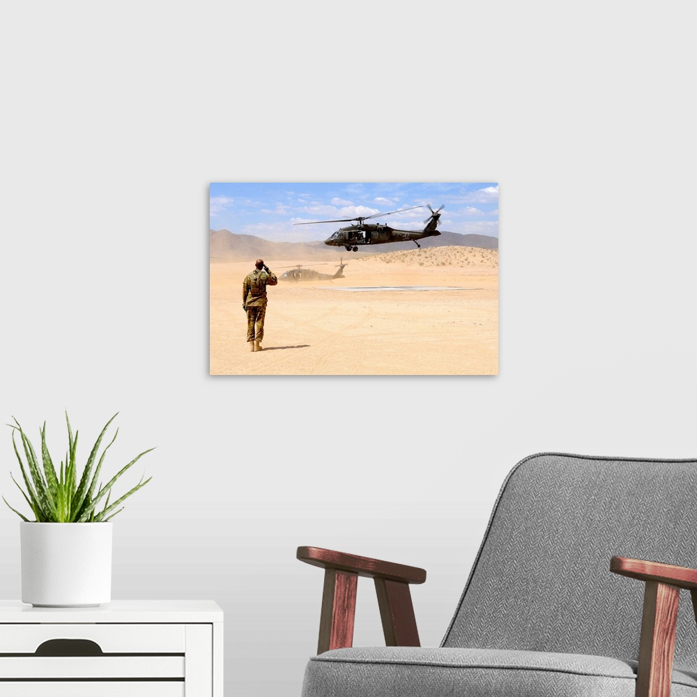 A modern room featuring August 4, 2012 - Brigade aviation officer salutes as a UH-60 Black Hawk helicopter lifts off from...