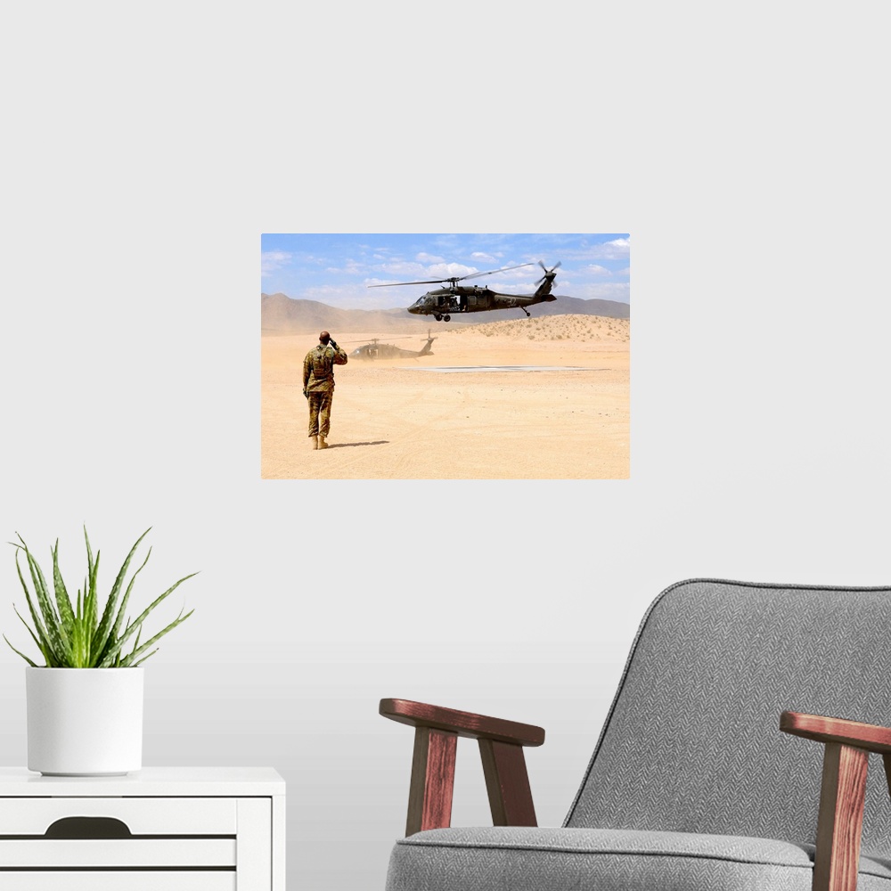 A modern room featuring August 4, 2012 - Brigade aviation officer salutes as a UH-60 Black Hawk helicopter lifts off from...