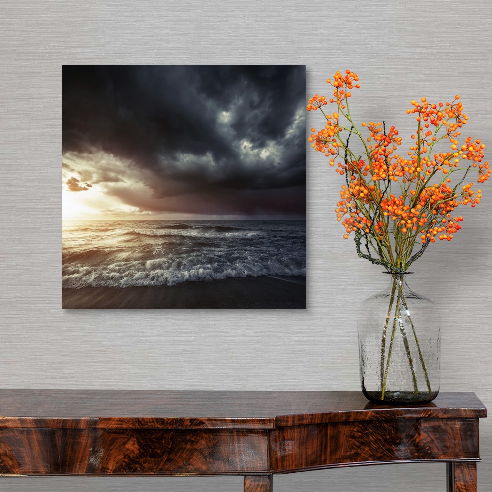 A traditional room featuring Bright sunset against a wavy sea with stormy clouds, Hersonissos, Crete, Greece.