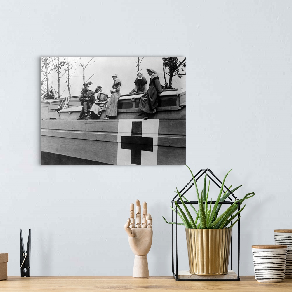 A bohemian room featuring World War One photograph of British nurses and a Medical Corps Sergeant on board a hospital barge...