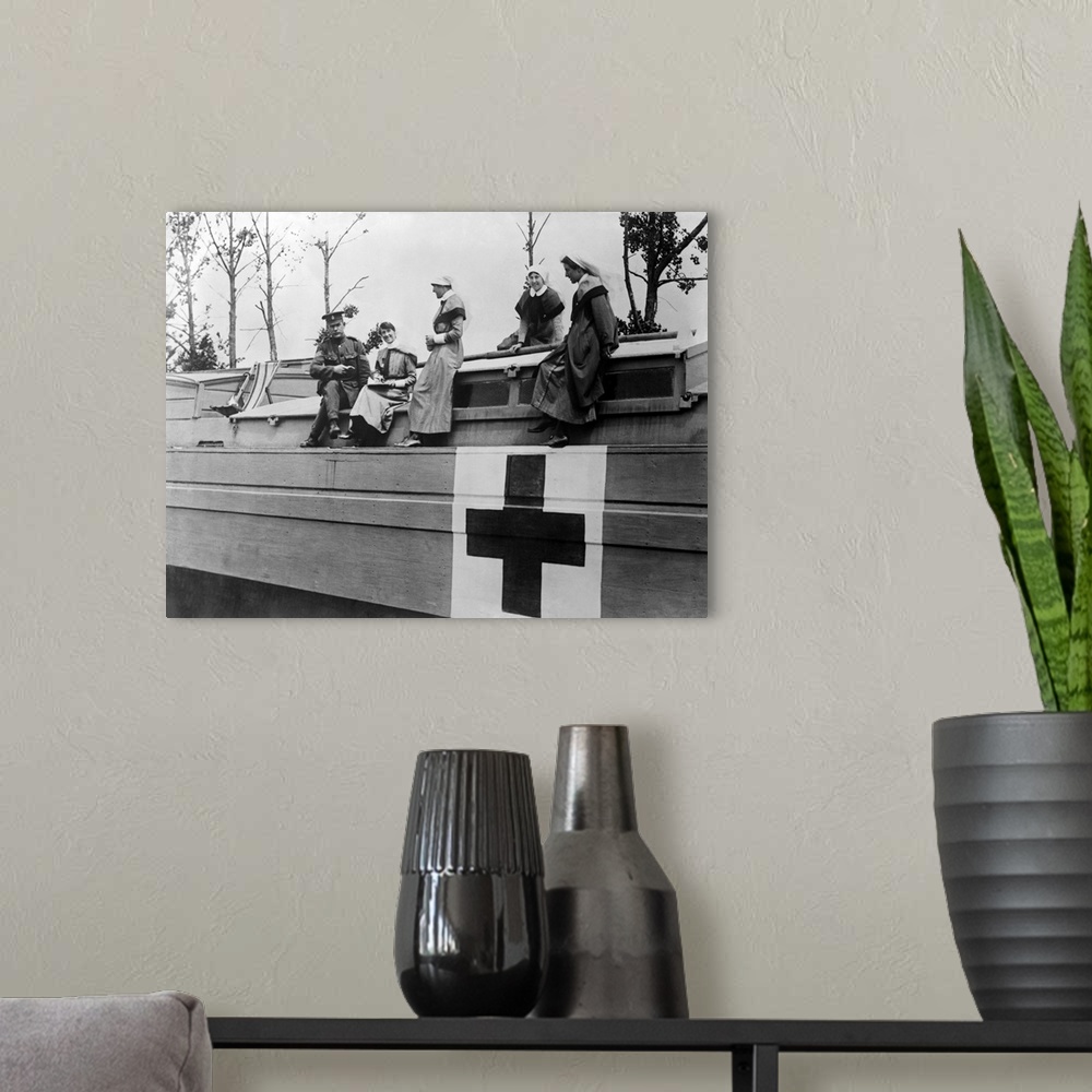 A modern room featuring World War One photograph of British nurses and a Medical Corps Sergeant on board a hospital barge...
