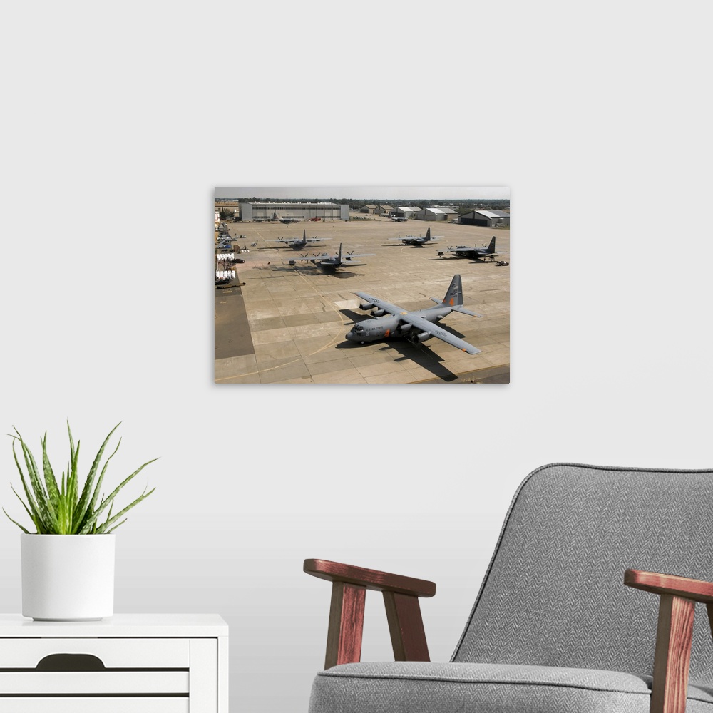 A modern room featuring C130 Hercules aircraft stationed at an airbase