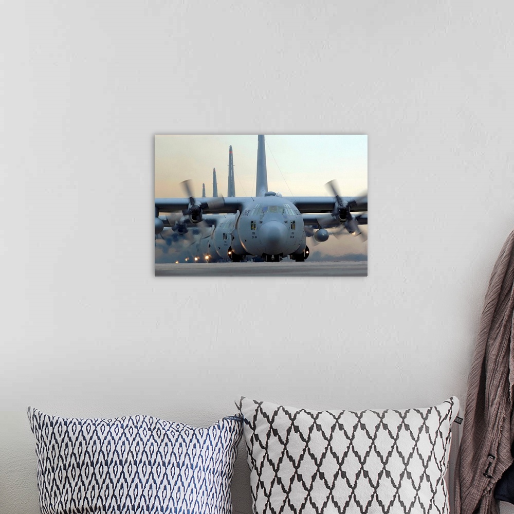 A bohemian room featuring Several of these tried and true military aircrafts line up on a runway with their massive propell...