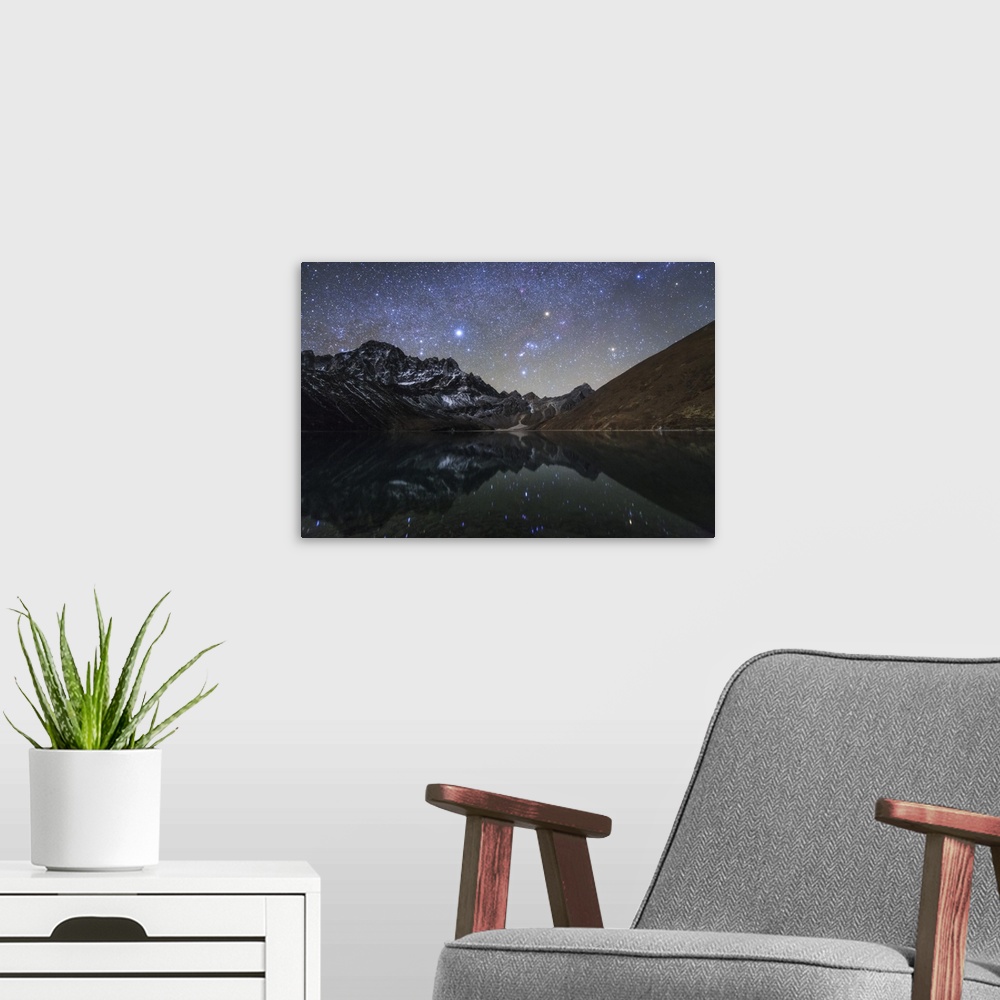 A modern room featuring The winter Milky Way with bright Sirius, Orion and Aldebaran shining above the moonlight mountain...