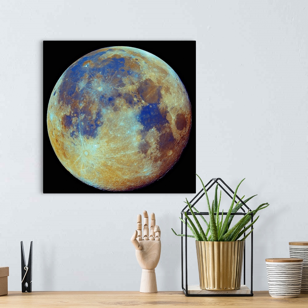 A bohemian room featuring Square photo on canvas of the moon highlighted in color on a dark backdrop.