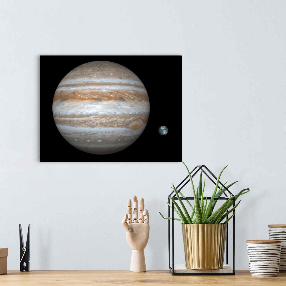 A bohemian room featuring Artist's concept comparing the size of the gas giant Jupiter with that of the Earth.