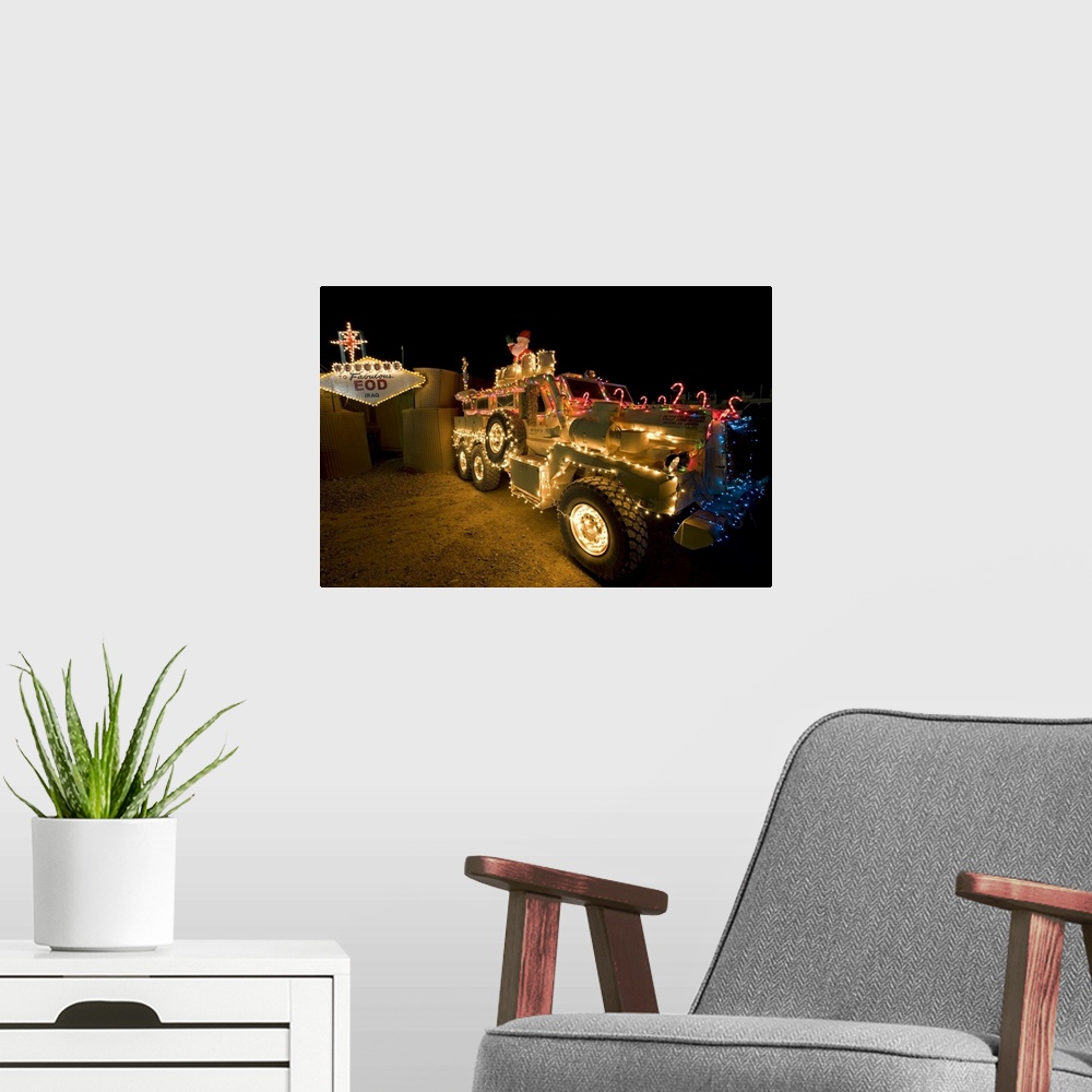A modern room featuring Cougar MRAP is adorned in holiday lights parked in front of EOD Iraq