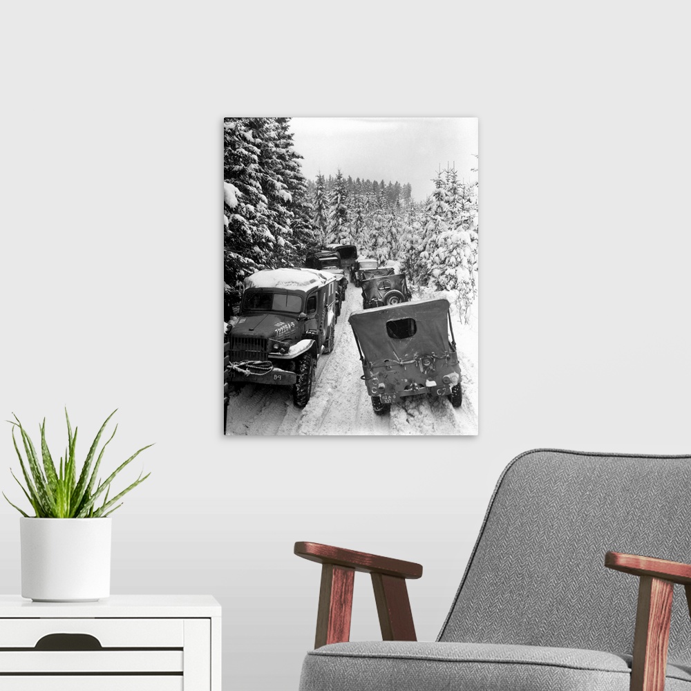 A modern room featuring Deep snow banks on a narrow road halt military vehicles in Belgium, 1945.