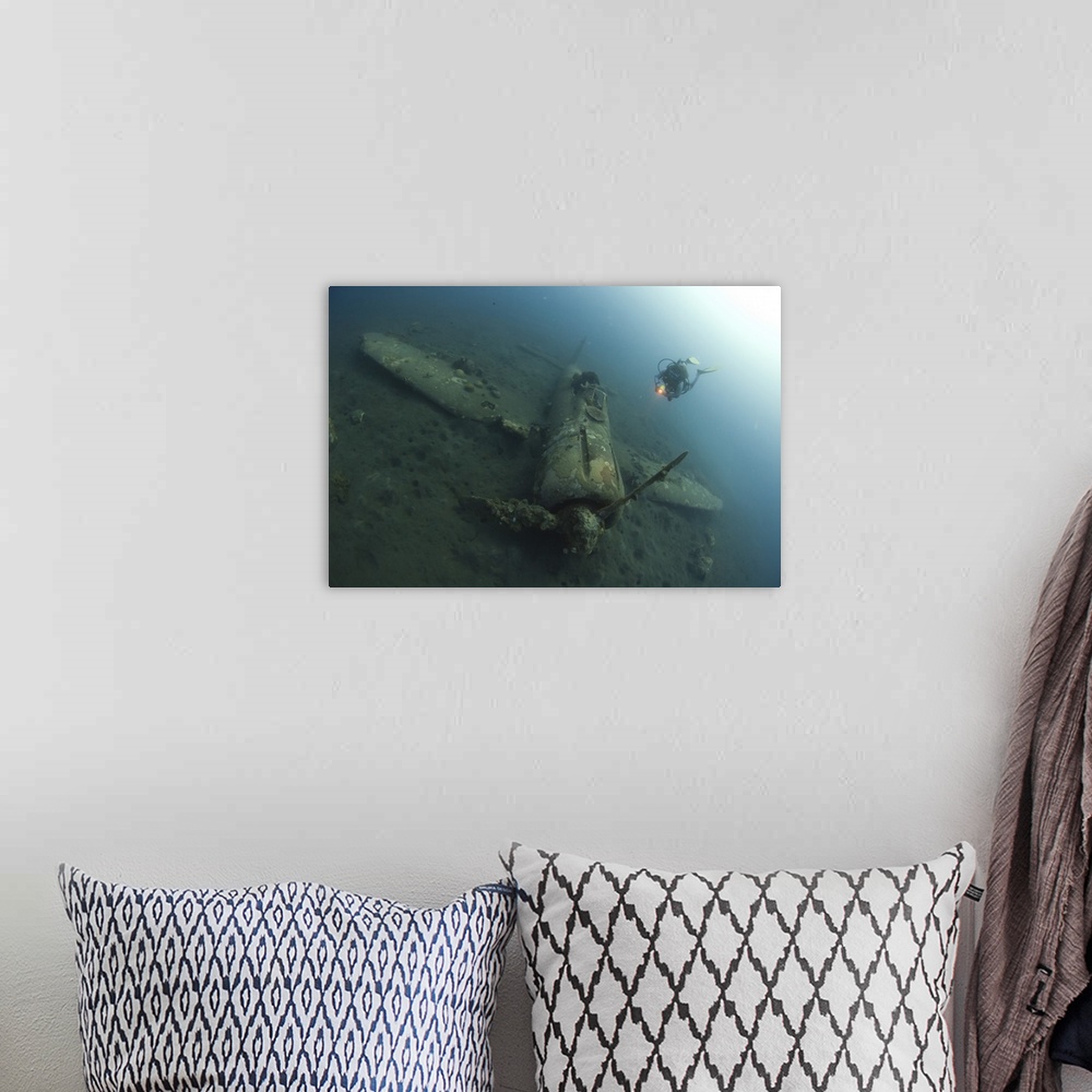 A bohemian room featuring Diver explores the wreck of a Mitsubishi Zero fighter plane.