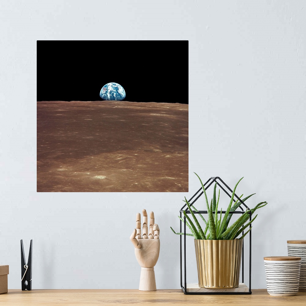 A bohemian room featuring View from the moon's surface of the earth rising over the horizon. It is a sight only a few astro...
