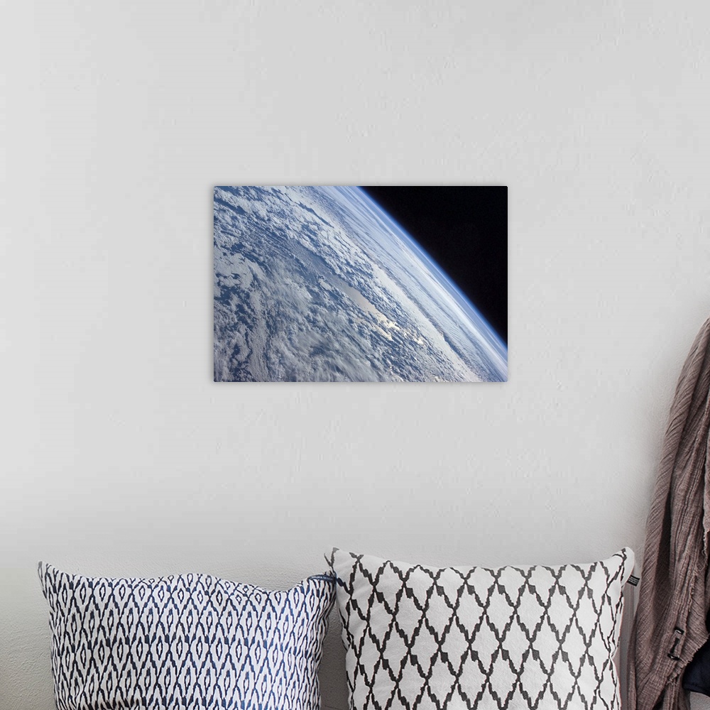 A bohemian room featuring Earths horizon against the blackness of space
