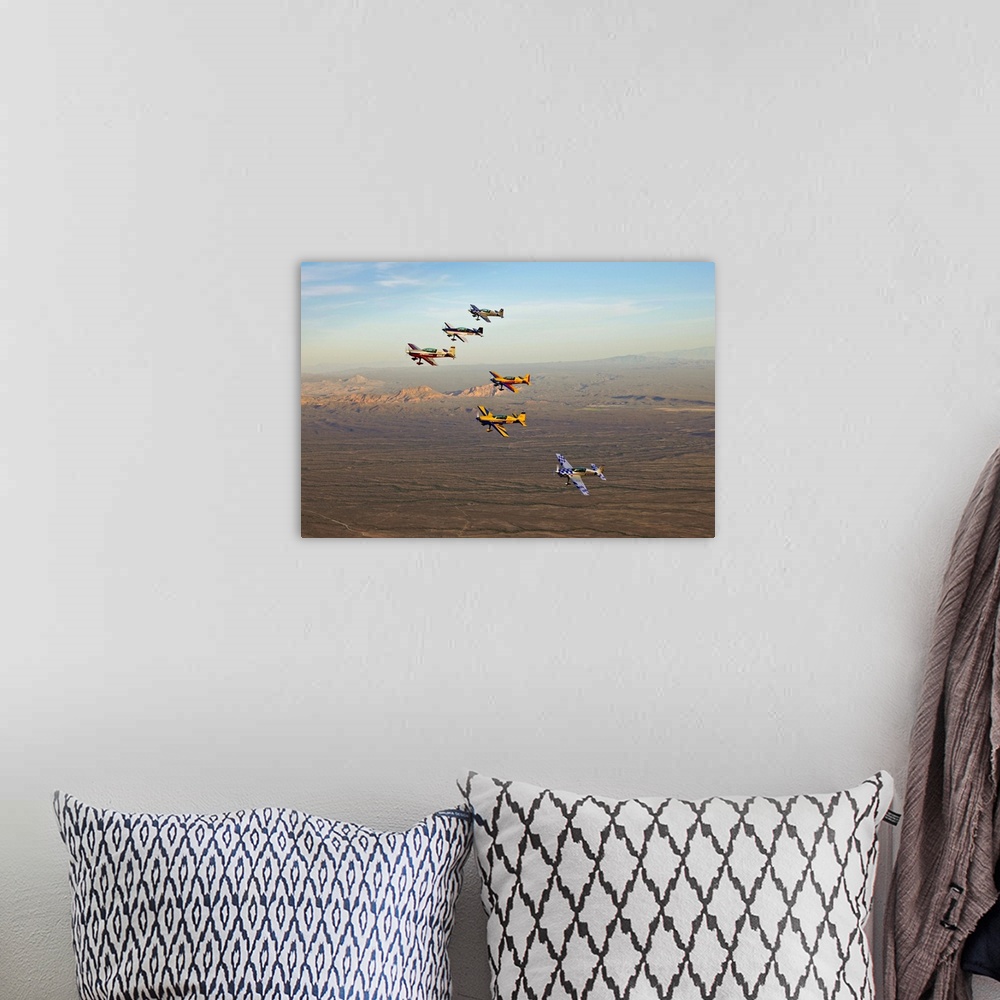 A bohemian room featuring Extra 300 aerobatic aircraft fly in formation during APS training in Mesa, Arizona.