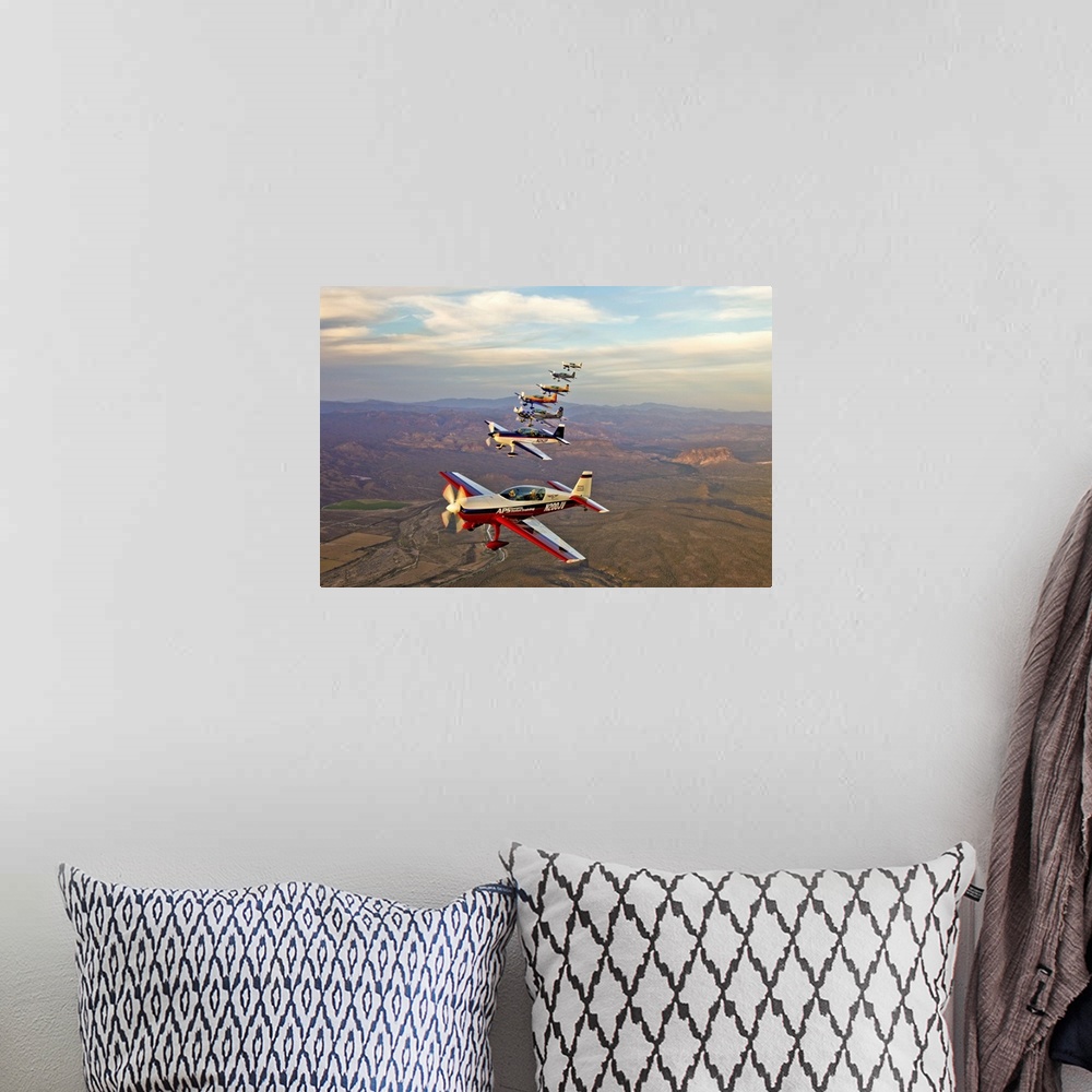 A bohemian room featuring Extra 300 aerobatic aircraft fly in formation over Mesa, Arizona.