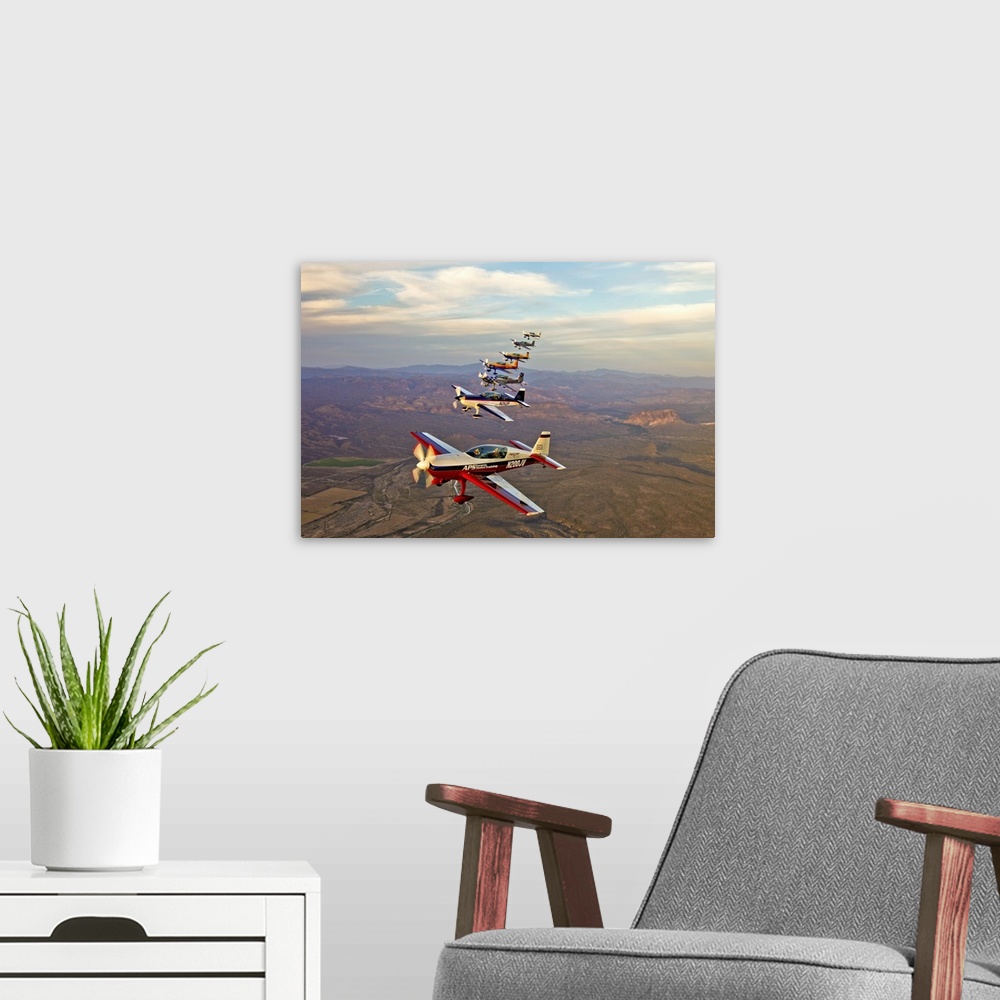 A modern room featuring Extra 300 aerobatic aircraft fly in formation over Mesa, Arizona.