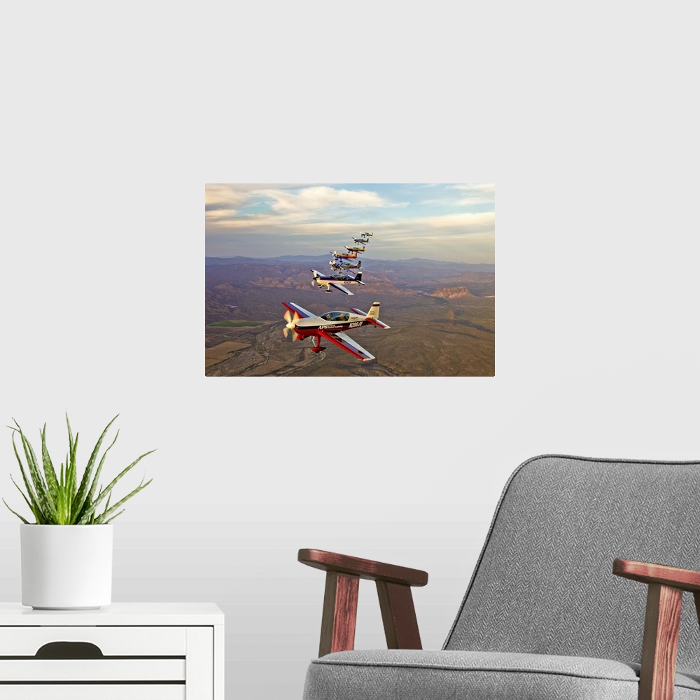 A modern room featuring Extra 300 aerobatic aircraft fly in formation over Mesa, Arizona.