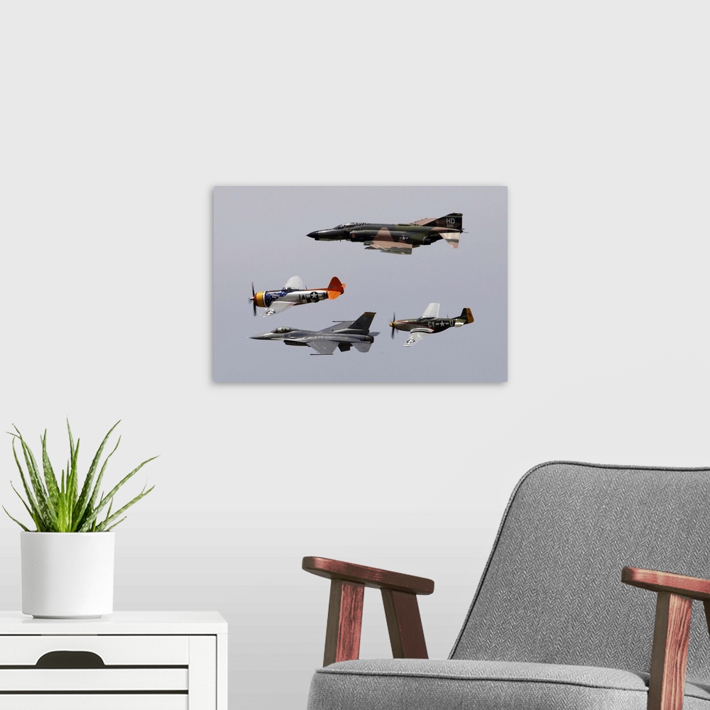 A modern room featuring An F-4 Phantom, P-47 Thunderbolt, F-16 Fighting Falcon and P-51 Mustang fly in a heritage flight.