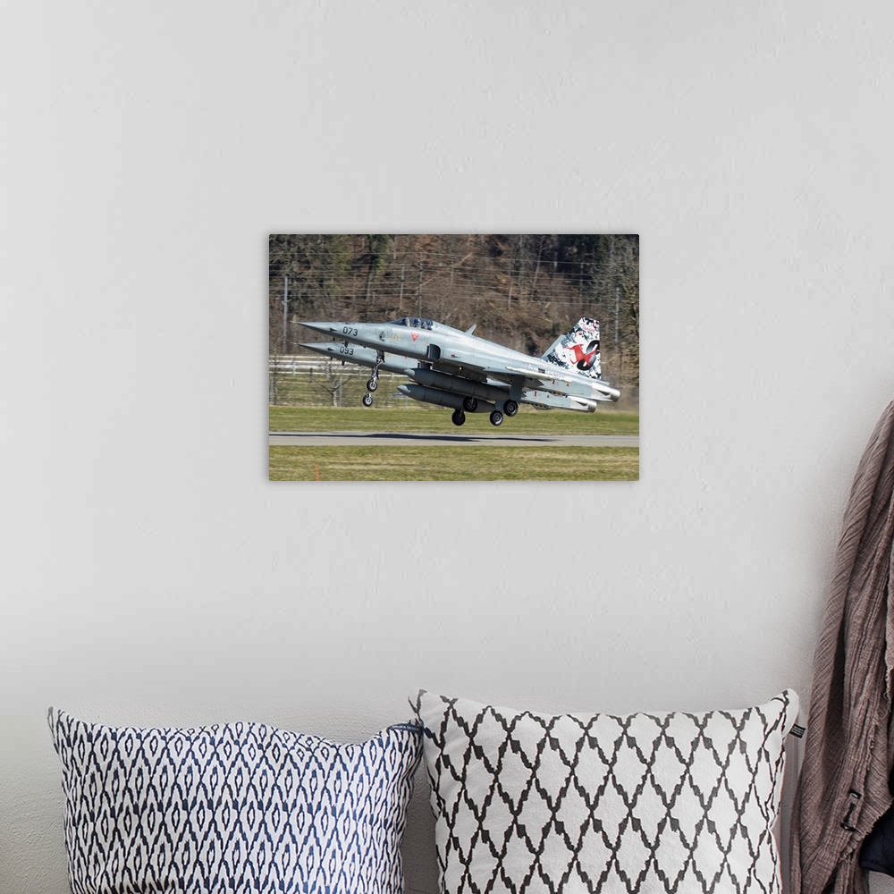 A bohemian room featuring F-5E Tiger II from the Swiss Air Force taking off.