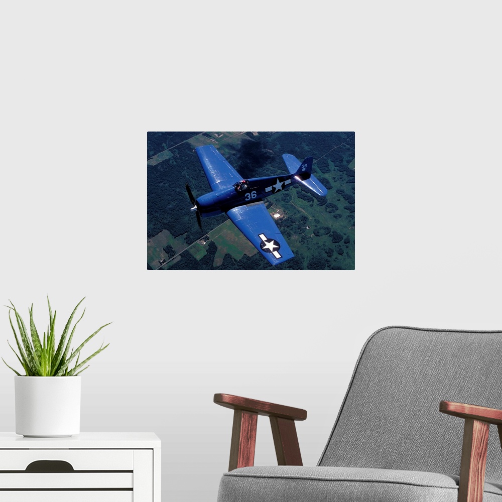 A modern room featuring F-6F Hellcat flying over Oshkosh, Wisconsin.