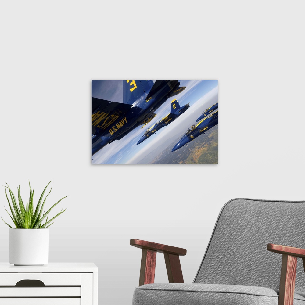 A modern room featuring F/A-18 Hornets of the Blue Angels fly in formation over Colorado.