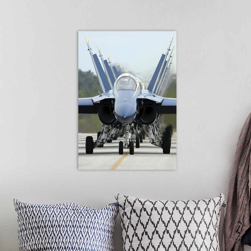 A bohemian room featuring F/A-18A Hornets assigned to the Blue Angels, taxi back to their flight line.