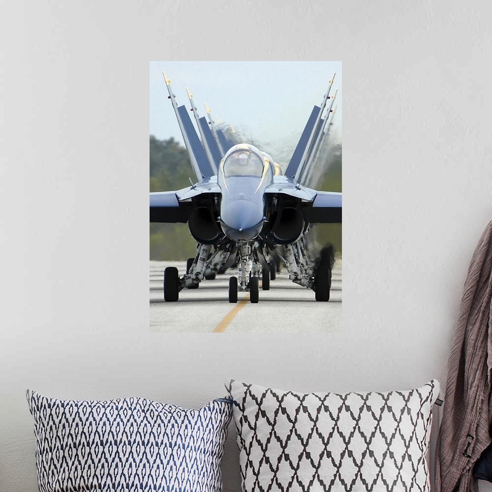 A bohemian room featuring F/A-18A Hornets assigned to the Blue Angels, taxi back to their flight line.