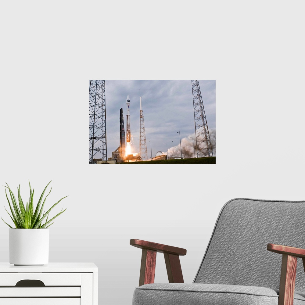 A modern room featuring Fire and smoke signal the liftoff of the Atlas V/Centaur launch vehicle