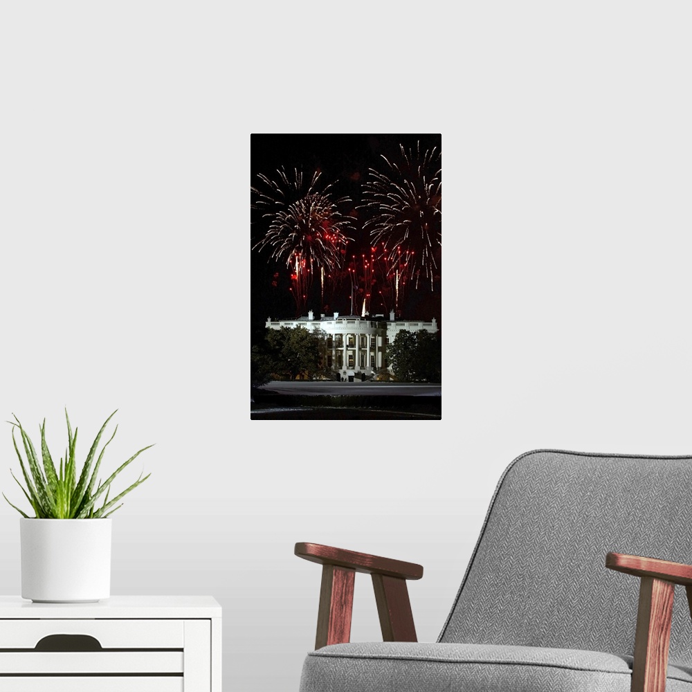 A modern room featuring Plumes of firewords explode over top of a lit up White House in Washington, DC.