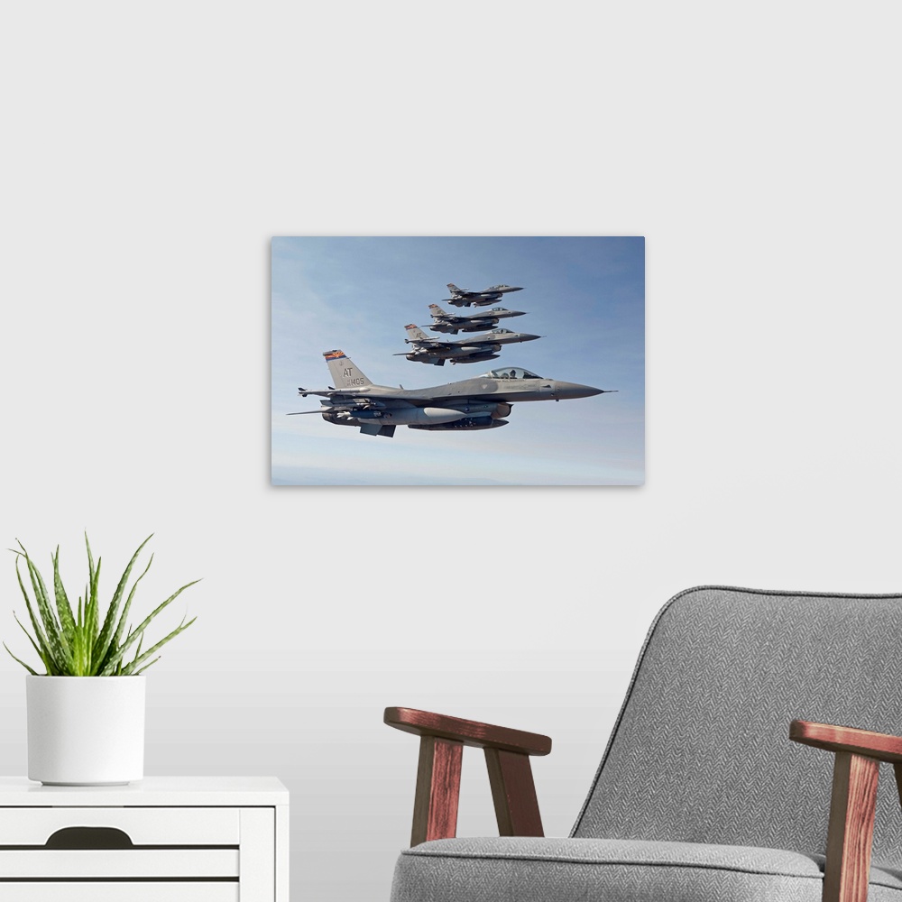 A modern room featuring Four F-16's from the Air National Guard Air Force Reserve Test Center fly in formation during a t...
