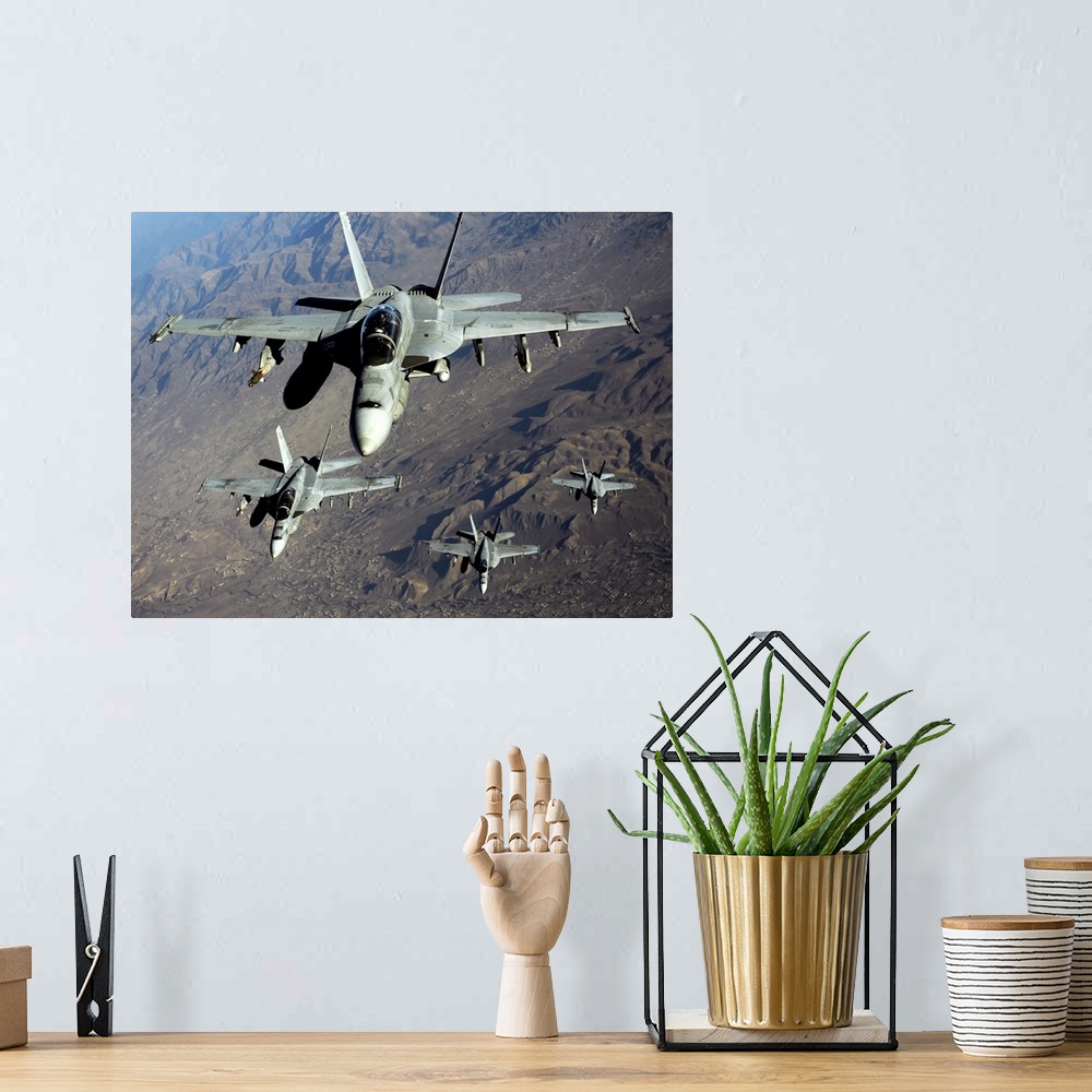 A bohemian room featuring November 25, 2010 - Four U.S. Navy F/A-18 Hornet aircraft fly over mountains in Afghanistan.