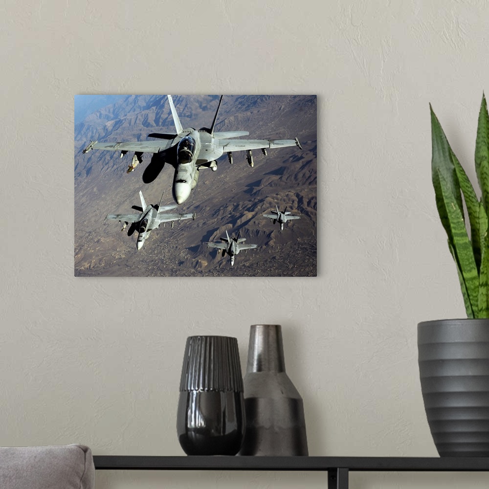 A modern room featuring November 25, 2010 - Four U.S. Navy F/A-18 Hornet aircraft fly over mountains in Afghanistan.