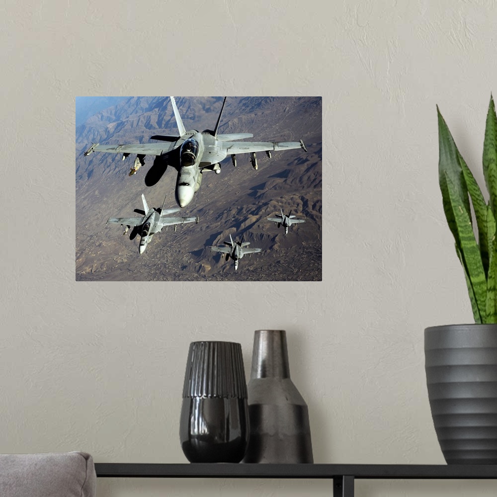 A modern room featuring November 25, 2010 - Four U.S. Navy F/A-18 Hornet aircraft fly over mountains in Afghanistan.