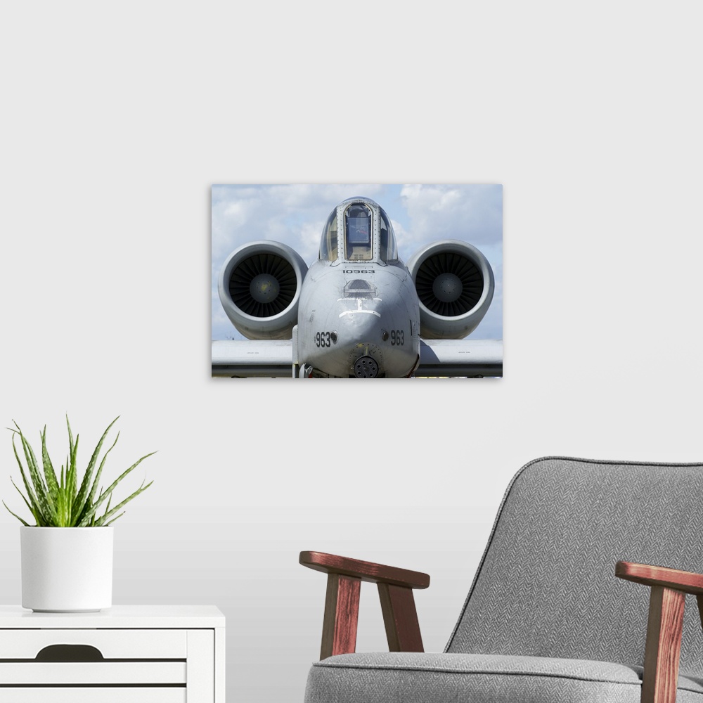 A modern room featuring Front view of an A-10A Thunderbolt II.