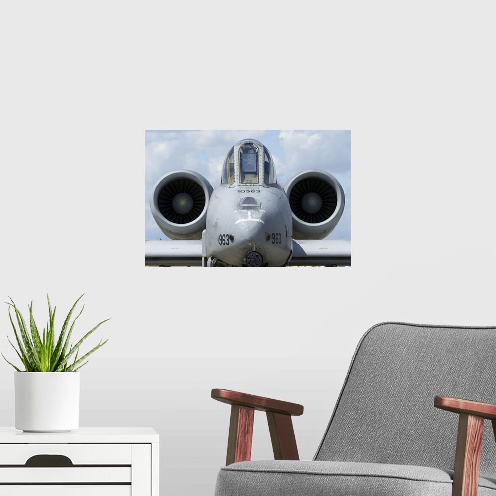 A modern room featuring Front view of an A-10A Thunderbolt II.